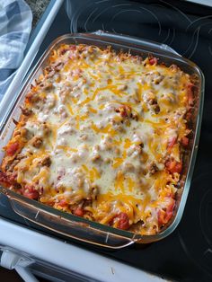 a casserole dish with meat and cheese in it on top of an oven