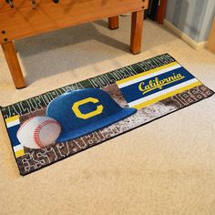 a baseball themed rug on the floor next to a table