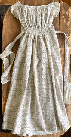 "Early cotton print baby gown. Wide neckline with tiny handmade rick rack trimmed cap sleeves. Ruched front waist with tie backs. Cotton print in browns on off-white ground. Completely hand stitched. Dates to 1870s and was worn by Effie Howell born 1872, later Dietrich. Very good condition with some light stains.  Measurements: 9\" across front at underarms length 29\"" Little Dorrit, Baby Girls Dresses, Cottagecore Outfits, Cotton Sundress, Rick Rack, Baby Gown, Lovely Clothes, Feminine Outfit