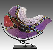 a purple and red glass sculpture sitting on top of a metal stand