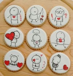 six decorated cookies on a wooden platter with stickers depicting people in love and feelings