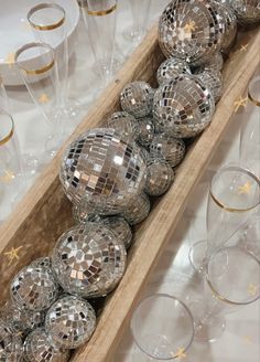 a wooden box filled with lots of shiny disco balls