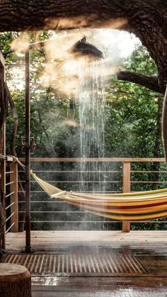 a hammock in the middle of a tree with water coming out of it