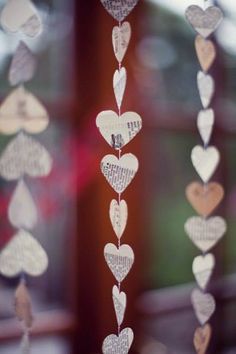 some white and silver hearts hanging from a window