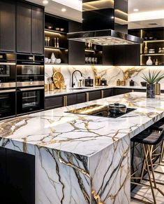 a large kitchen with marble counter tops and black cabinets, along with bar stools