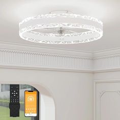 a remote control is attached to the ceiling in this modern living room with white walls and trimmings