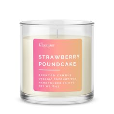 a candle that is sitting in front of a white background with the words strawberry poundcake on