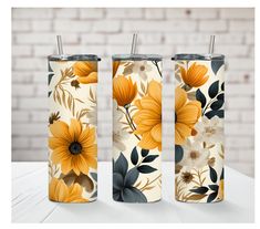 three different styles of floral tumbles on a white table with brick wall in the background