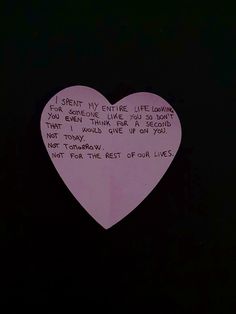 a paper heart with writing on it in the dark