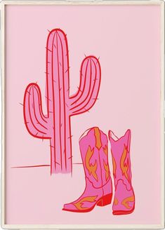 a pair of pink cowboy boots sitting next to a tall cactus on a pink background