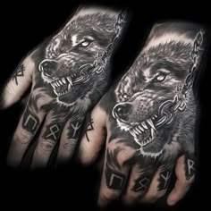 two hand tattoos with wolfs on them and chains hanging from the wrist, one is black