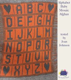 an orange and black crocheted afghan with the words alphabet written on it in different languages