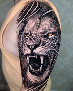 a man's arm with an animal tattoo on it, and the image of a lion