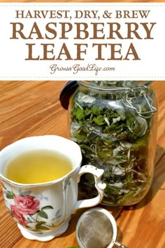 a glass jar filled with raspberry leaf tea next to a cup of green tea