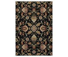 a black area rug with an ornate design on the front and back side, in various colors