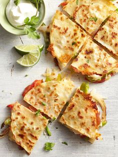 two quesadillas cut into squares on a cutting board