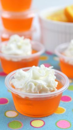 orange cups with whipped cream in them on a table