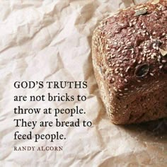 a loaf of bread sitting on top of a piece of paper with a quote about god's truth