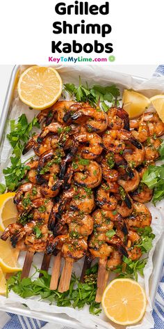 grilled shrimp kabobs with lemon wedges and parsley