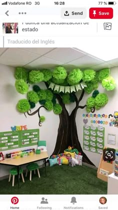 an office decorated in green and white with a tree on the wall above desks