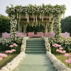 an outdoor wedding setup with flowers and greenery