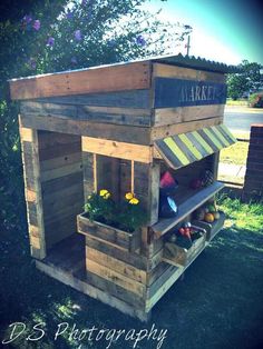 a wooden stand with vegetables and fruit in it