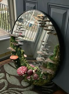 a mirror that has mushrooms on it in front of a door with moss growing out of it