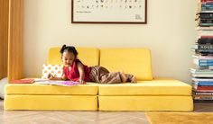 Girl reading books on a Lemonade Nugget® play couch Yellow Nugget Couch, The Nugget Couch, Fun Couch, Nugget Couch, Toy Gift Guide, What Is Play, The Nugget, Play Couch, Triangle Pillow