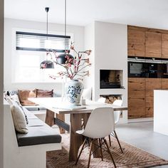 a dining room table with chairs and a vase on it