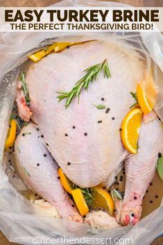 a whole turkey in a plastic bag with lemons and herbs on the side that says easy turkey brine