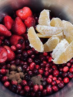 cranberries, oranges and spices in a metal bowl