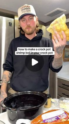 a man in a black hoodie is holding up a bag of crock pot