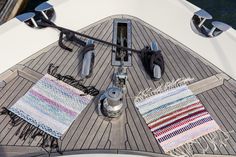 the inside of a sailboat with various rugs and accessories laid out on it