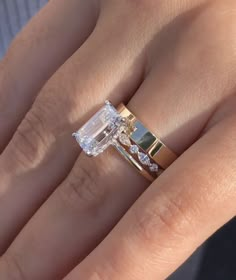 a woman's hand with an engagement ring on it