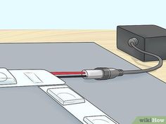 an electrical device connected to a power strip with wires and plugs on the ground