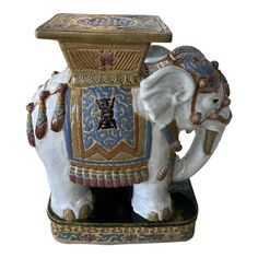 an elephant figurine with ornate designs on its trunk