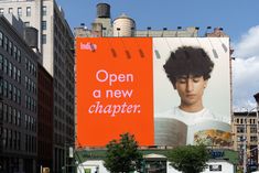 an orange billboard with the words open a new chapter on it