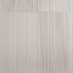 a white and beige wall with vertical lines on the bottom, one line at the top