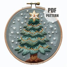 an embroidered christmas tree is shown in the hoop