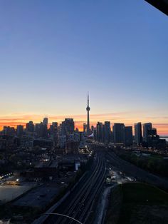 the city skyline is lit up at sunset