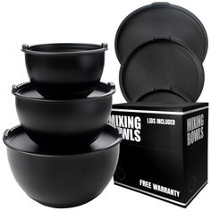 three black bowls are stacked on top of each other in front of a cardboard box