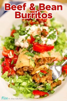 beef and bean burritos on a plate with lettuce