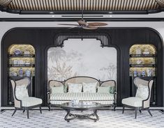 a living room filled with furniture and a ceiling fan