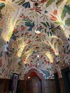 the ceiling is decorated with colorful flowers and leaves