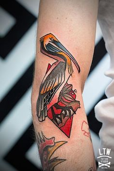 a pelican tattoo on the left arm