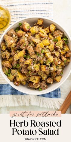 a white bowl filled with roasted potatoes on top of a blue and white table cloth