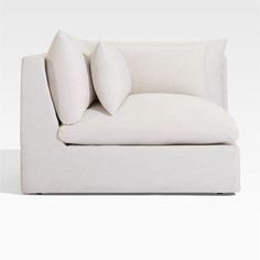 a white couch with two pillows on it's back and the seat upholstered