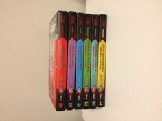 five dvd's stacked on top of each other in front of a white wall