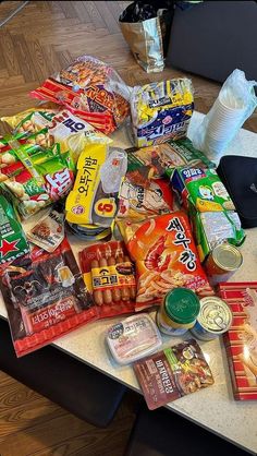 a table topped with lots of food on top of a hard wood floor next to a laptop computer