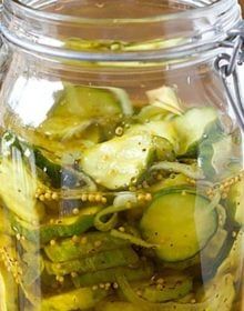 a jar filled with pickles sitting on top of a table